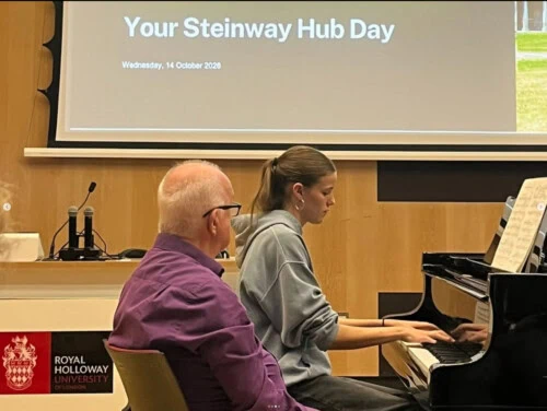 Esher student playing the piano at royal holloway